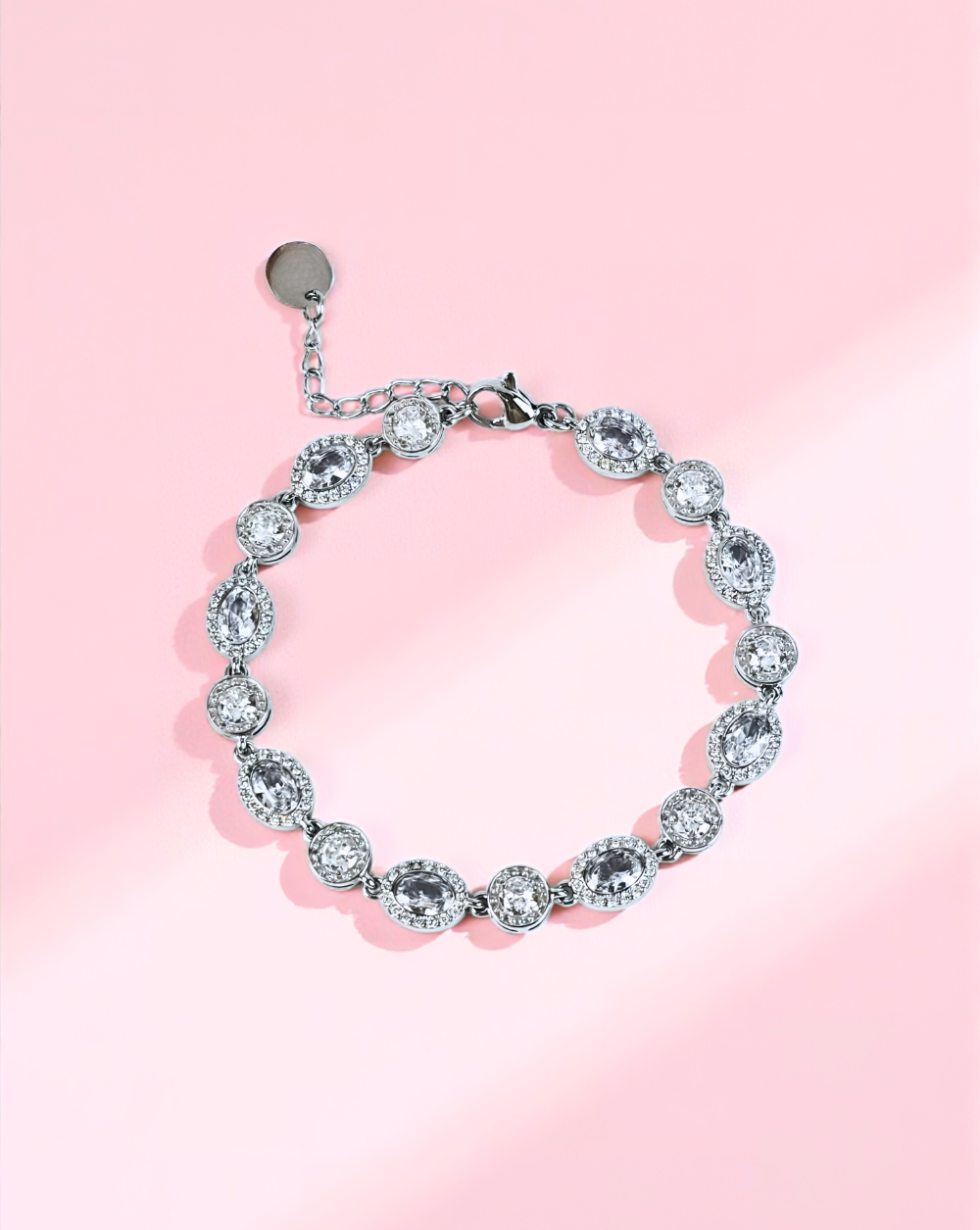 Srebrna zapestnica iz nerjavečega jekla z ovalnimi kamni na rožnatem ozadju – Trgovina Patrizia Ljubljana.