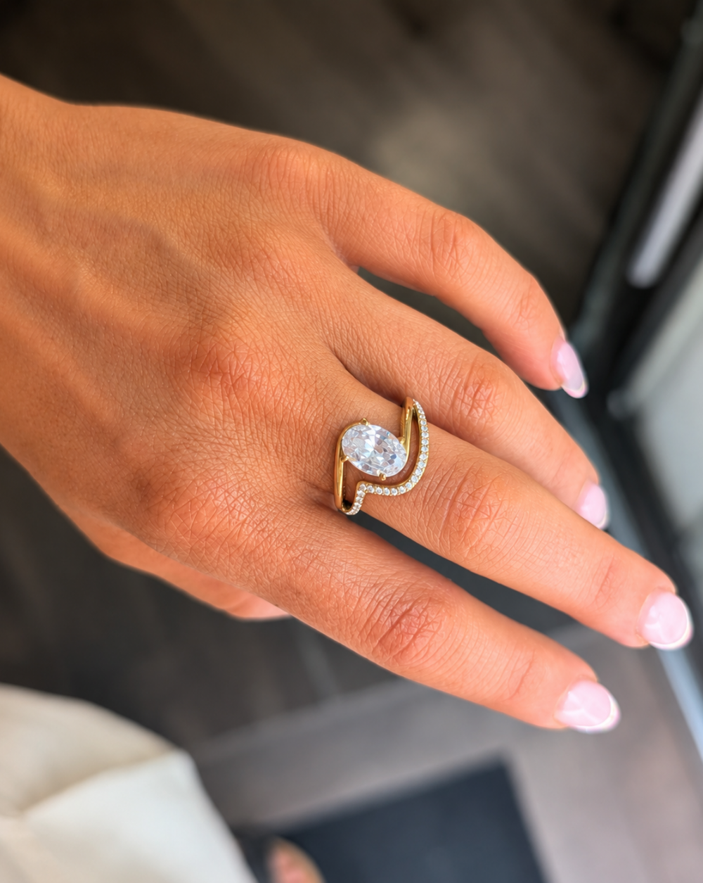 Gold " Ring " LUMI DROP made of stainless steel with a large, transparent teardrop-shaped crystal and a row of sparkling crystals – Trgovina Patrizia Ljubljana.