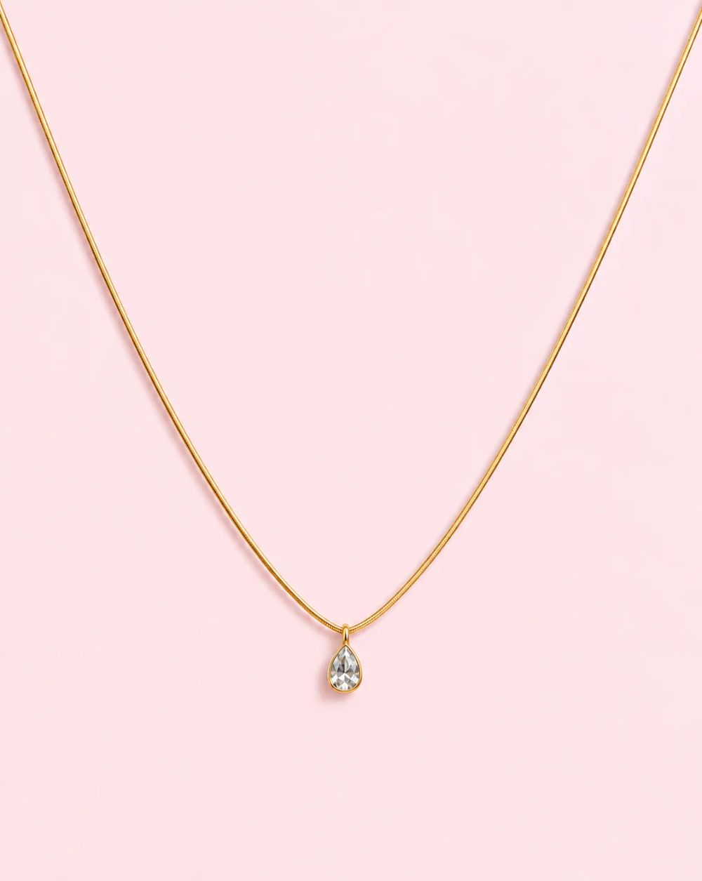Gold Snake-shaped necklace ELEGANT DROP made of stainless steel with a hanging, transparent, teardrop-shaped crystal – Trgovina Patrizia Ljubljana.