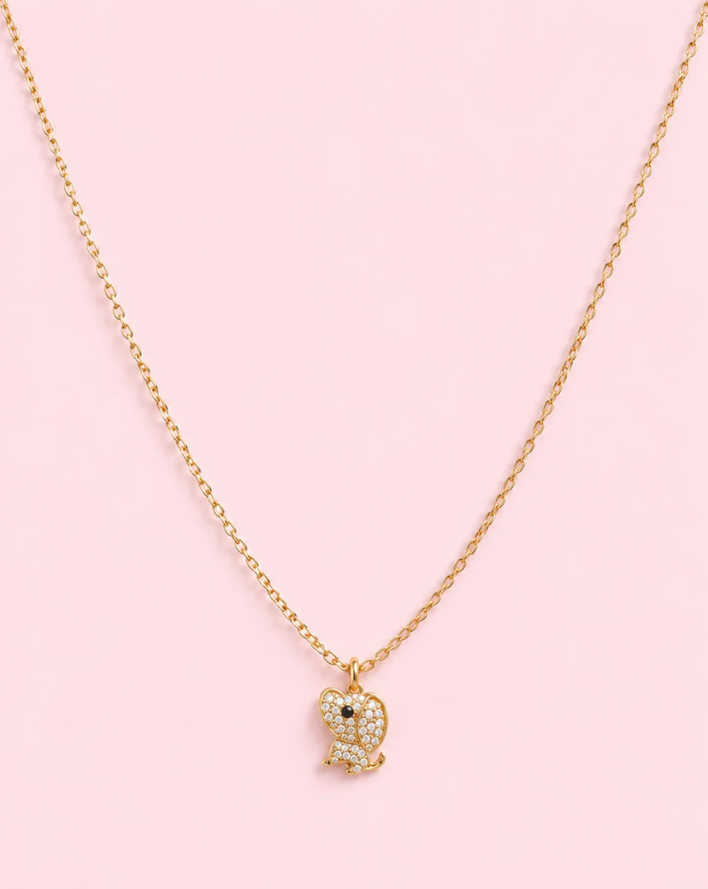 Gold necklace A stainless-steel PUPPY with a puppy-shaped pendant adorned with tiny sparkling crystals— Trgovina Patrizia , Ljubljana.