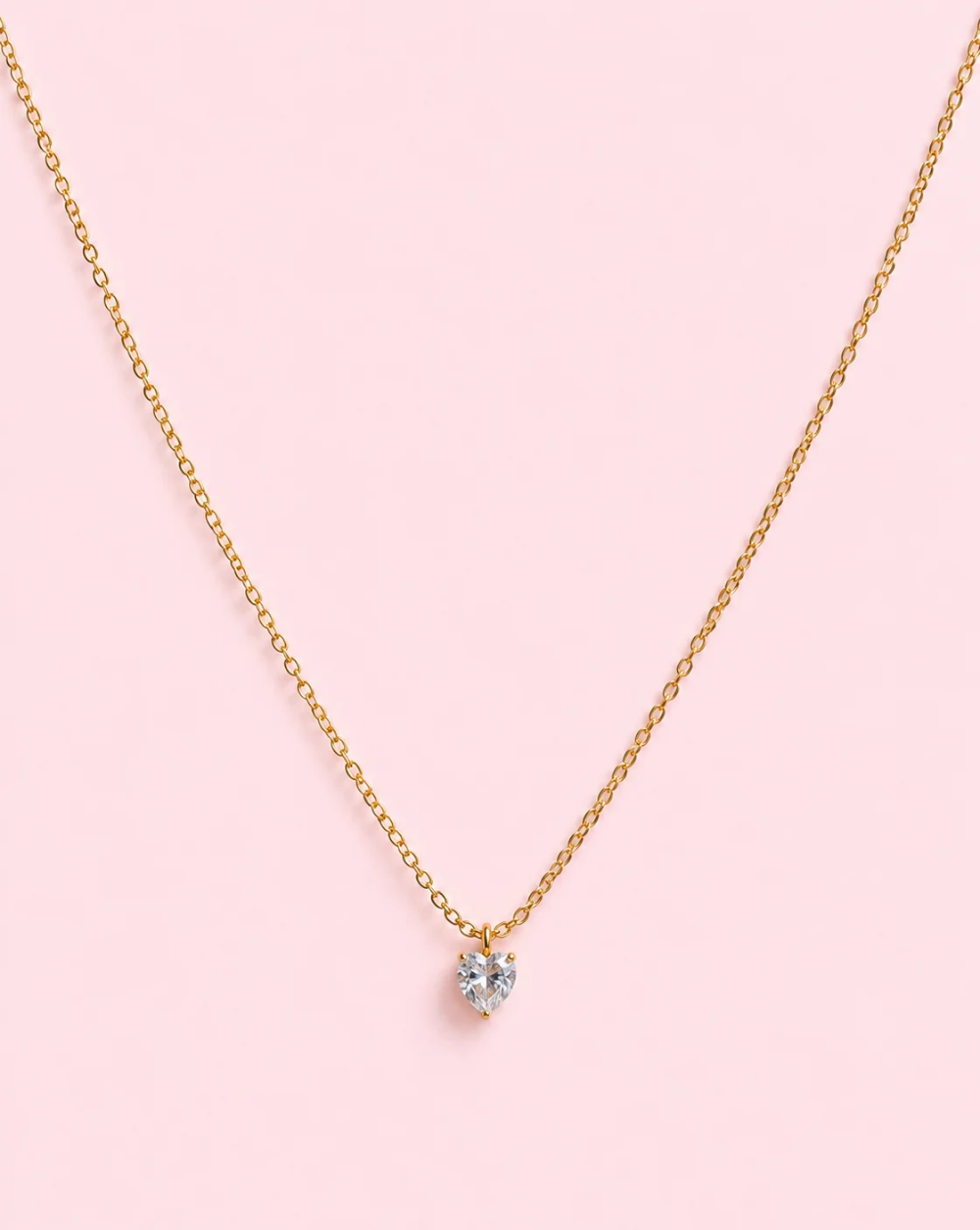 Gold necklace SOLITAIRE HEART , made of stainless steel with a sparkling, transparent, heart-shaped crystal pendant – Trgovina Patrizia Ljubljana.