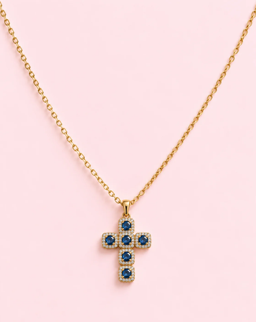 Gold necklace ROYAL CROSS, made of stainless steel, with a cross-shaped pendant adorned with brown and pink crystals and tiny sparkling stones— Trgovina Patrizia , Ljubljana.